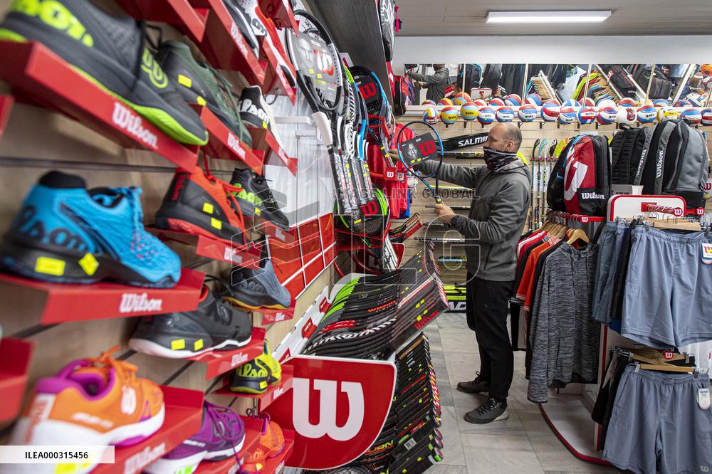 Shop with outdoor and sport equipment, sales manager, face mask