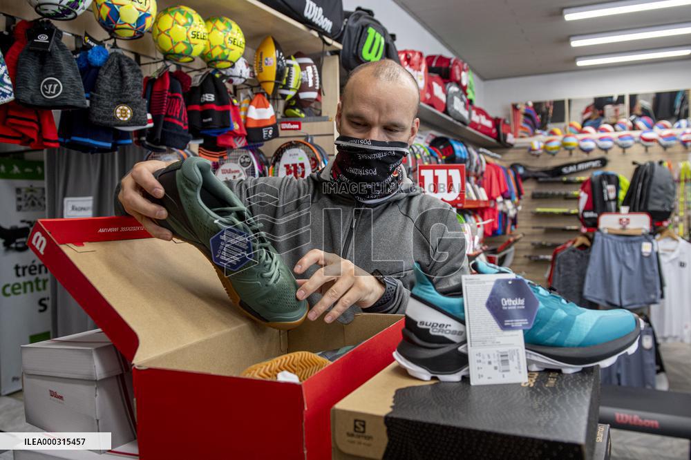 Shop with outdoor and sport equipment, sales manager, face mask