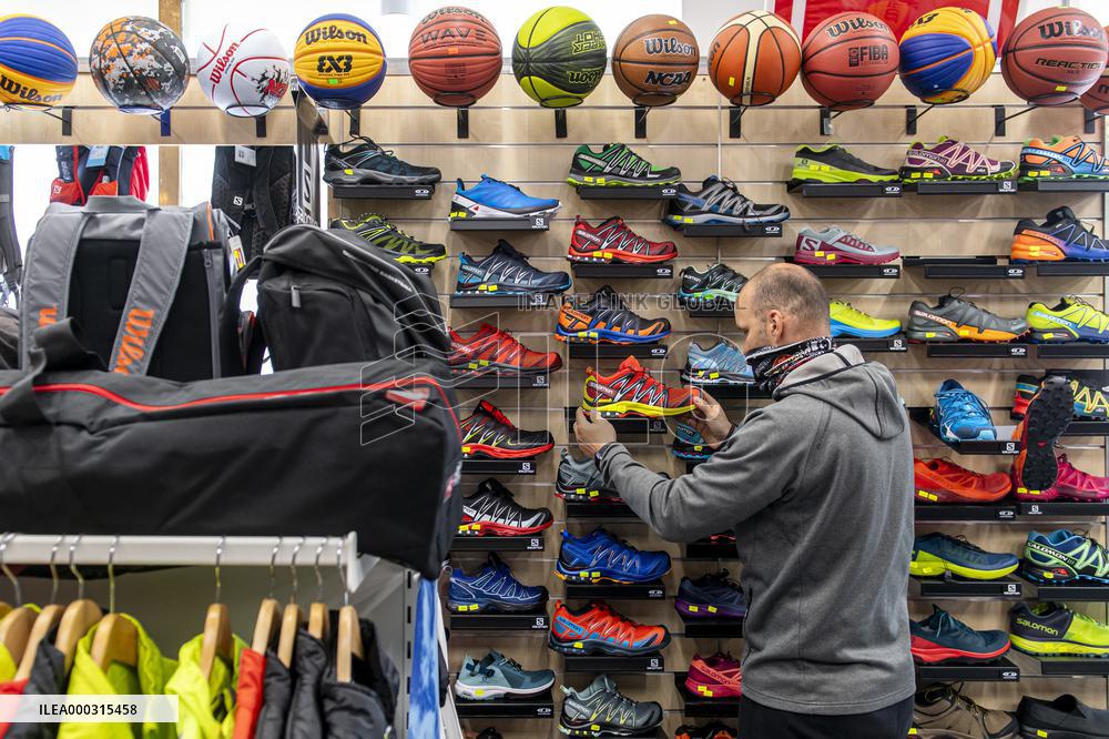 Shop with outdoor and sport equipment, sales manager, face mask