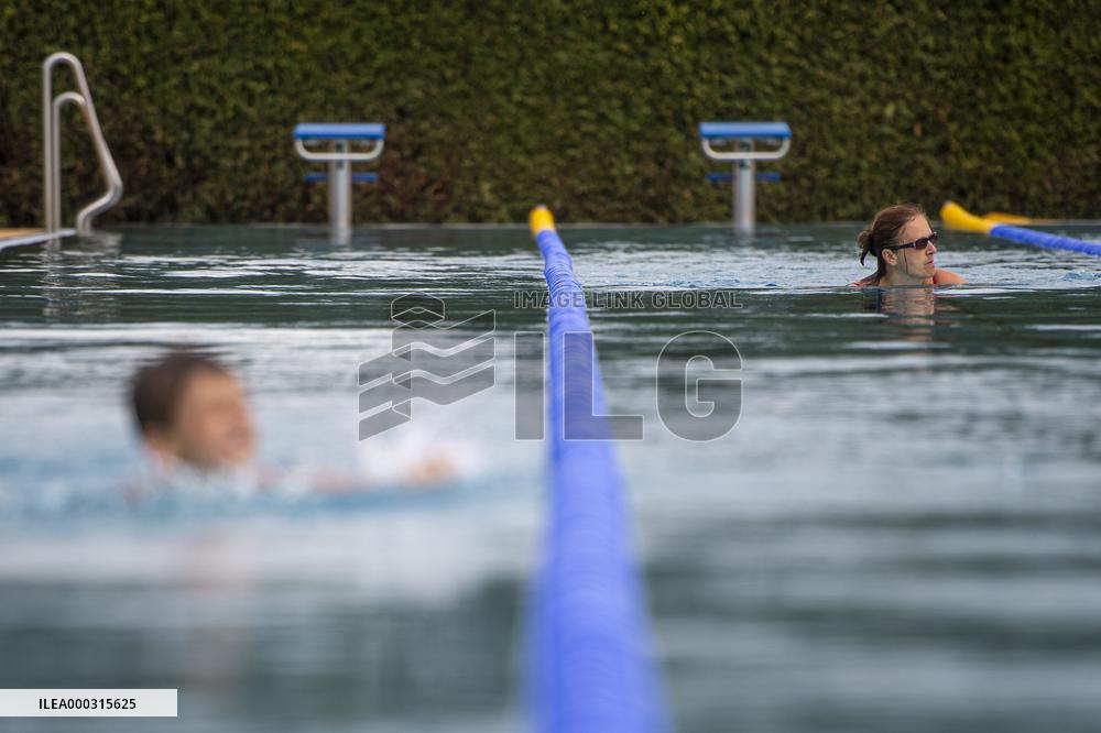 people enjoy warm weather in the Broumar lido, swimming pool