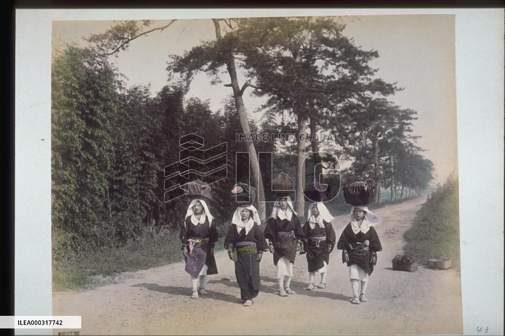Women carrying luggage on their heads