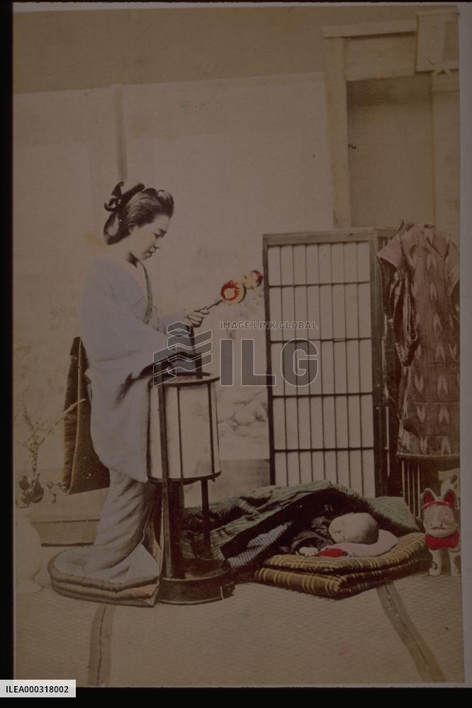 Mother putting a child to sleep