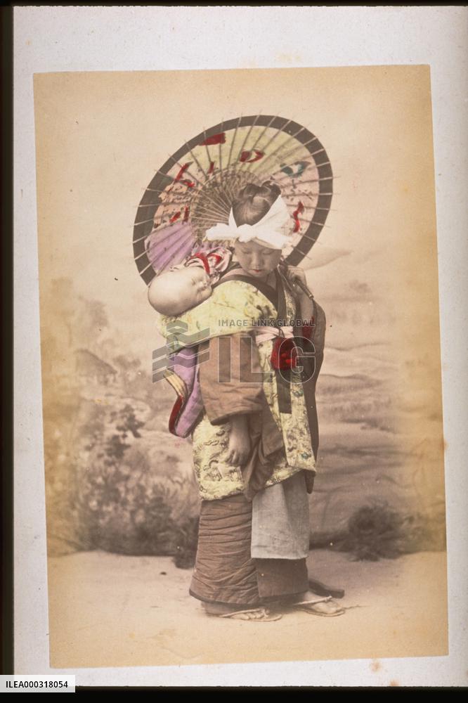 Girl carrying a baby on her back