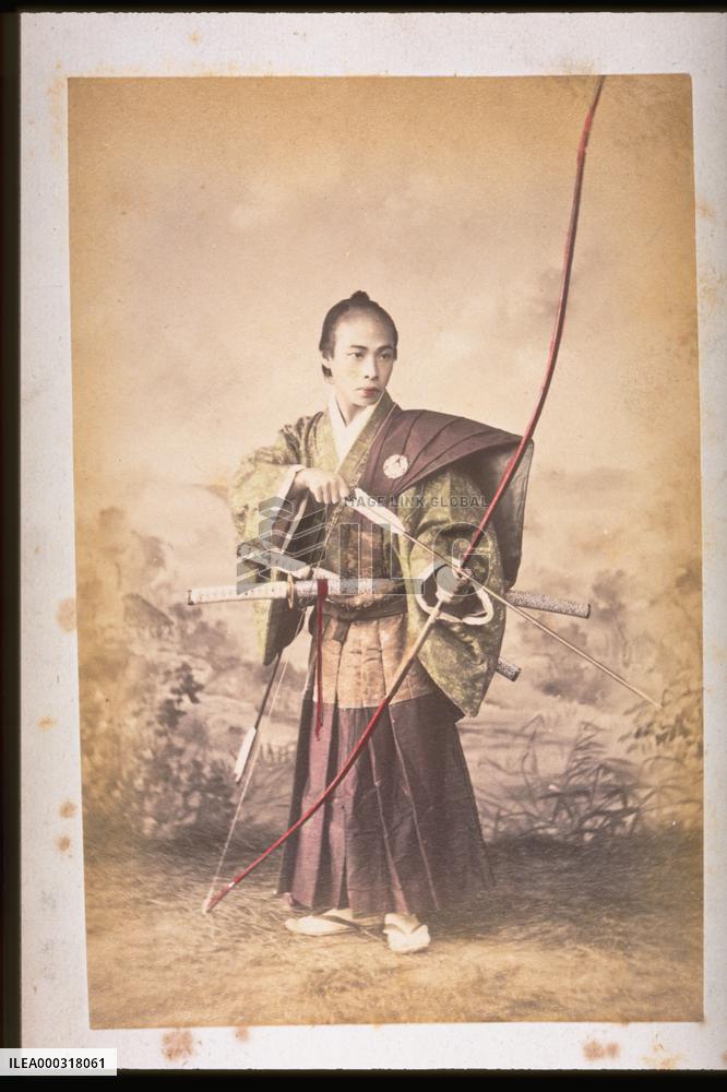 A samurai warrior ready to release an arrow from a bow
