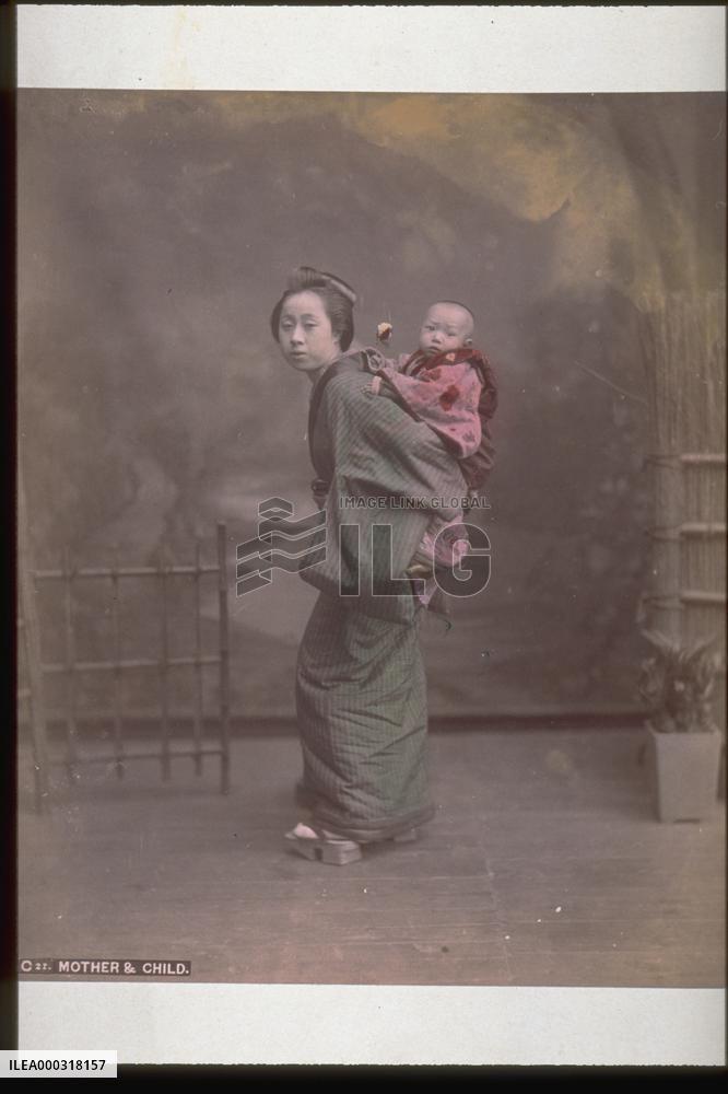 A mother carrying her child on her back