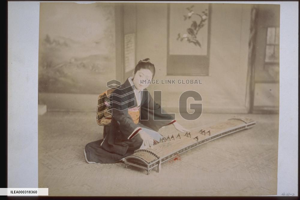 A woman playing the koto