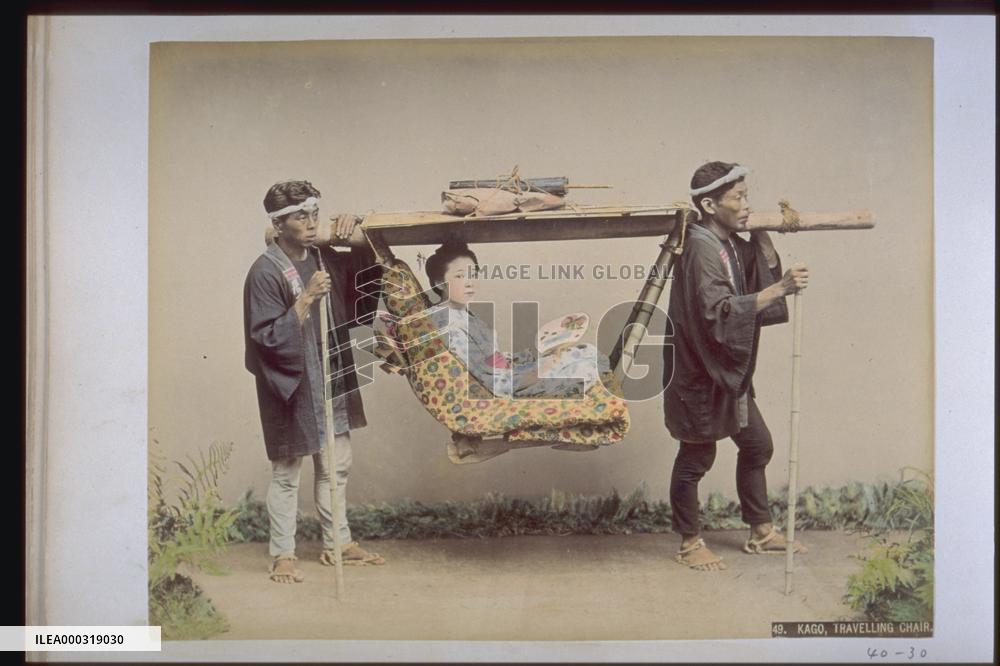 A woman in a basket palanquin