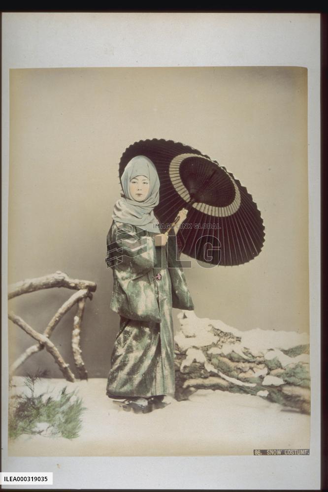 Woman in snow costume holding an umbrella