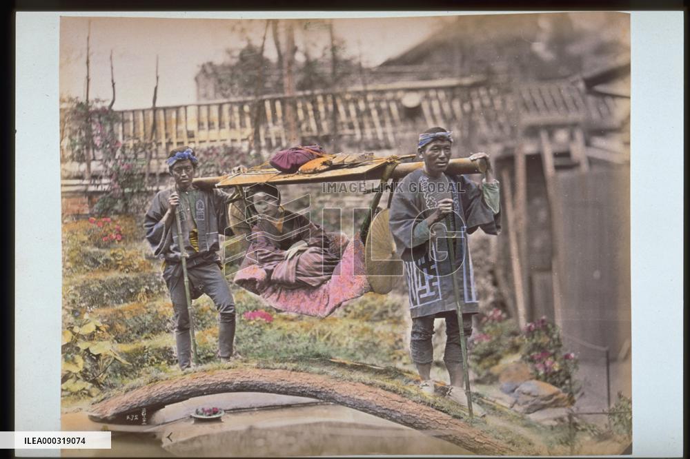 A woman in a basket palanquin