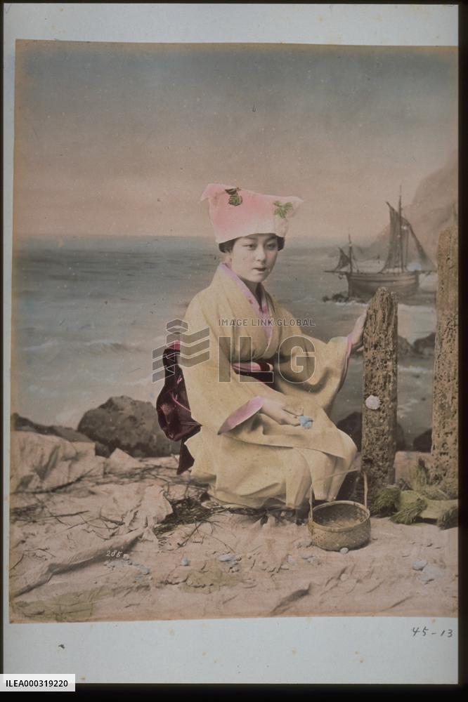 Woman collecting sea shells
