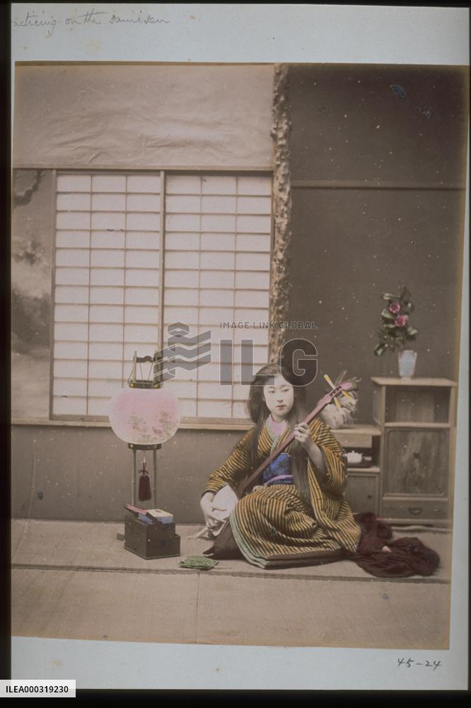 A woman playing the shamisen