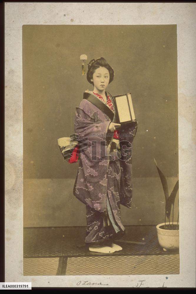 A woman carrying a portable candlestick