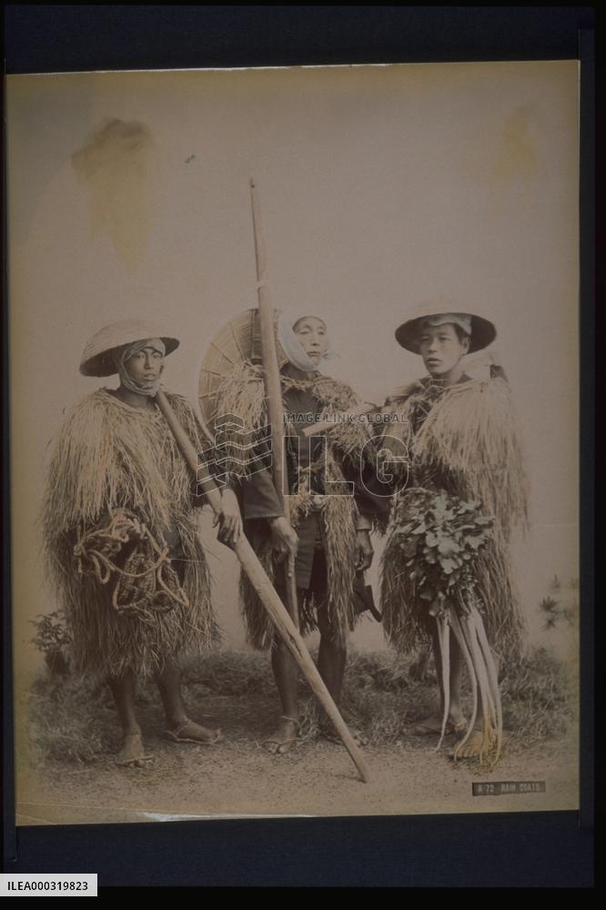 Farmers wearing straw raincoats and caps
