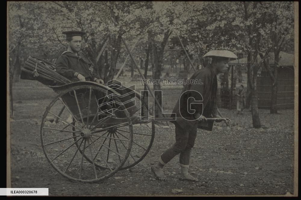 A jinrikisha carrying a foreign sailor