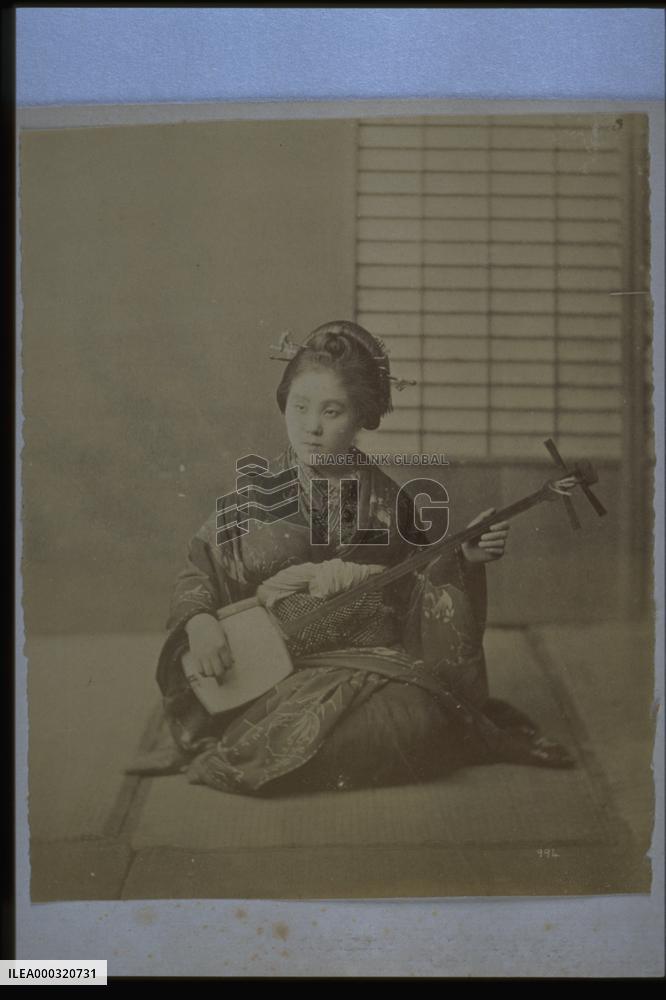 A woman playing the shamisen