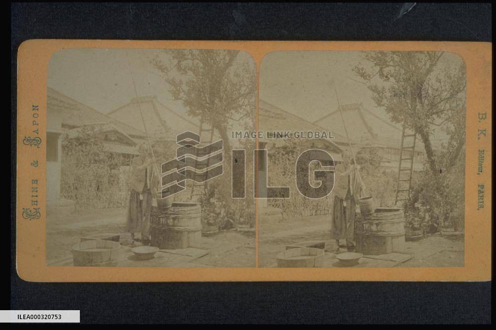 A samurai warrior drawing water from a well