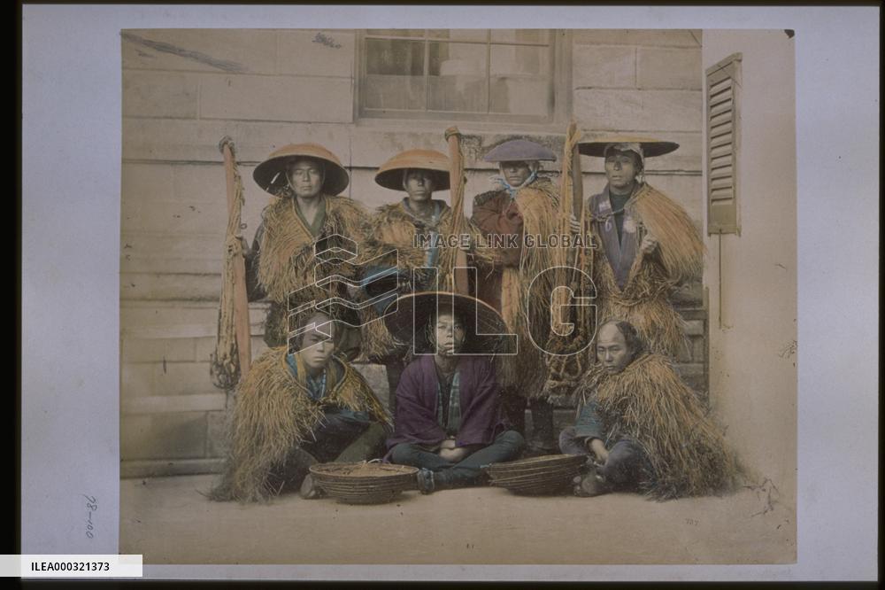 Farmers holding rope baskets,wearing straw raincoats and caps