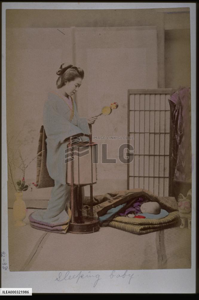 A woman putting her child to bed