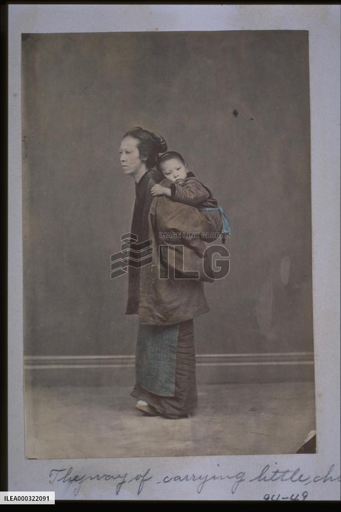 A woman carrying a child on her back