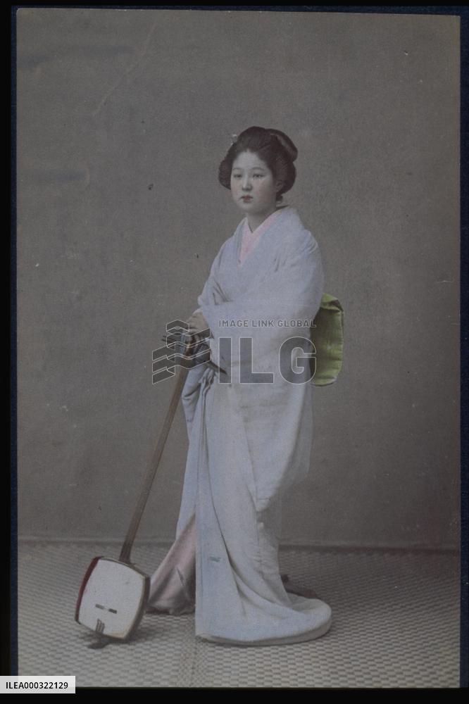 A woman holding a shamisen