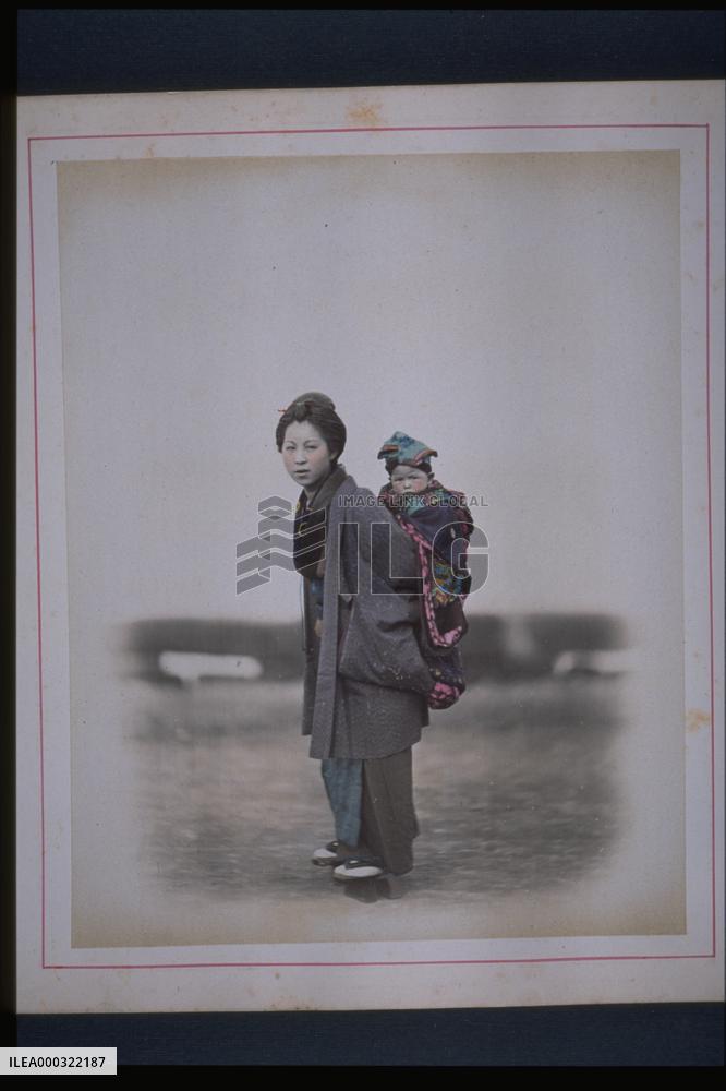 A mother carrying her child on her back