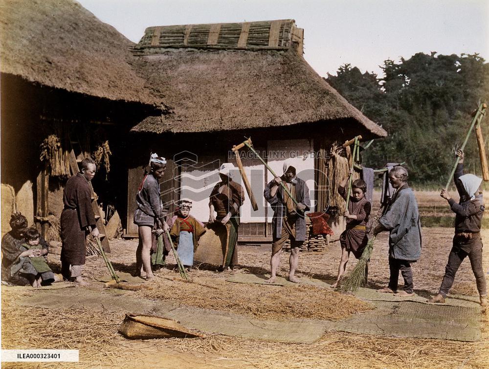 Threshing at a farm house