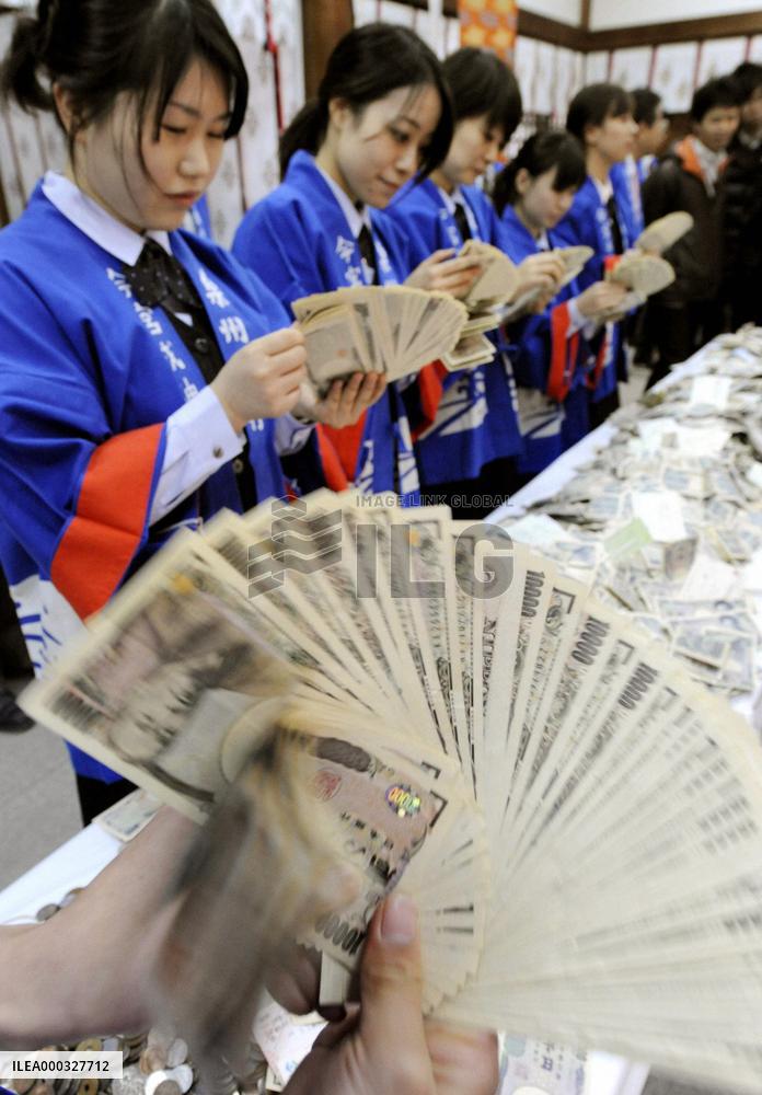 Bankers count money offered at shrine