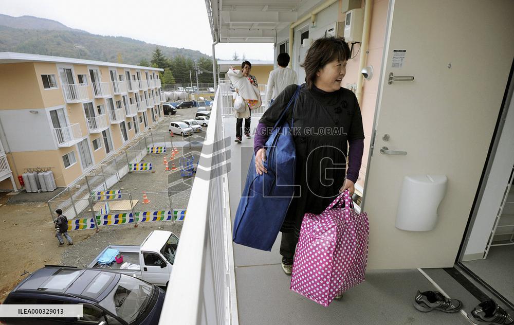 People moving into three-story temporary housing complex