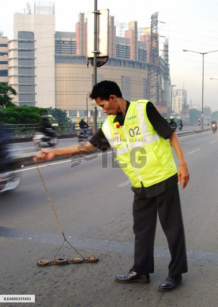 Cleaning up 'nail land mines' in Jakarta
