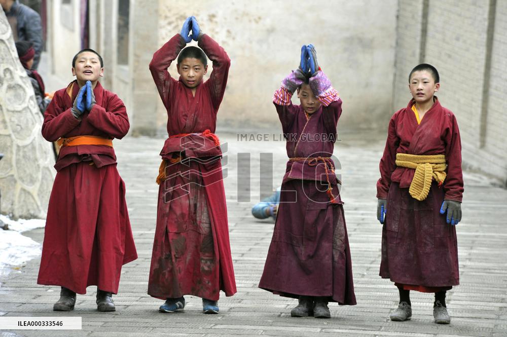 Young lamas walk in prayer in China