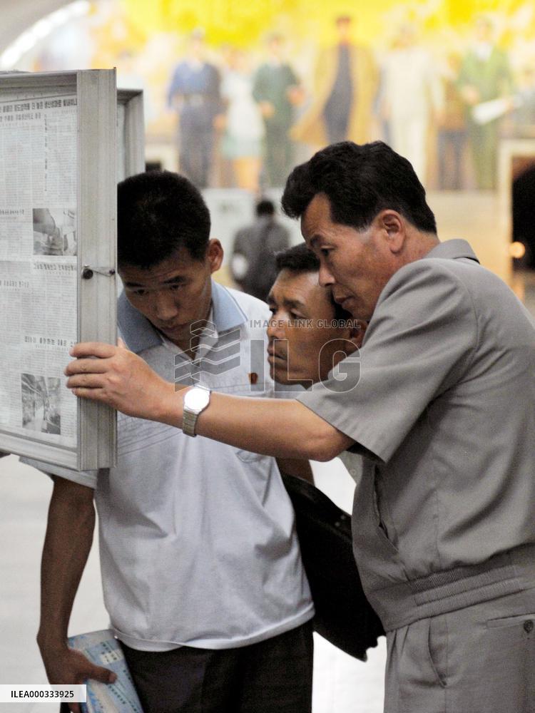 N. Korea citizens read newspaper at subway station