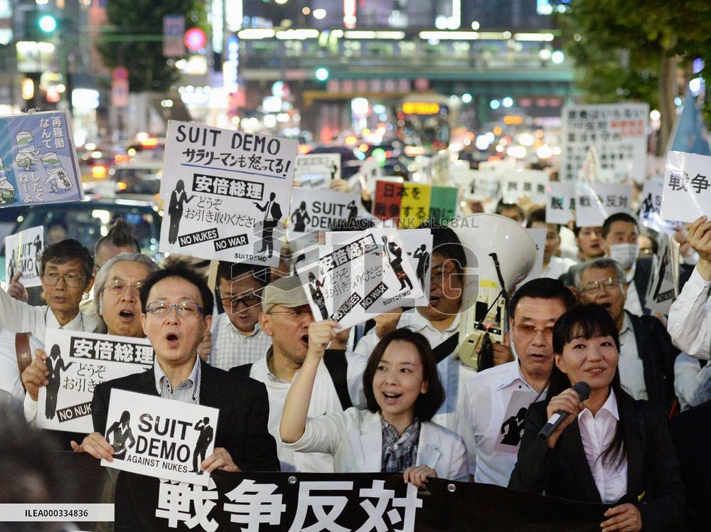 Workers in business wear protest against Abe gov't