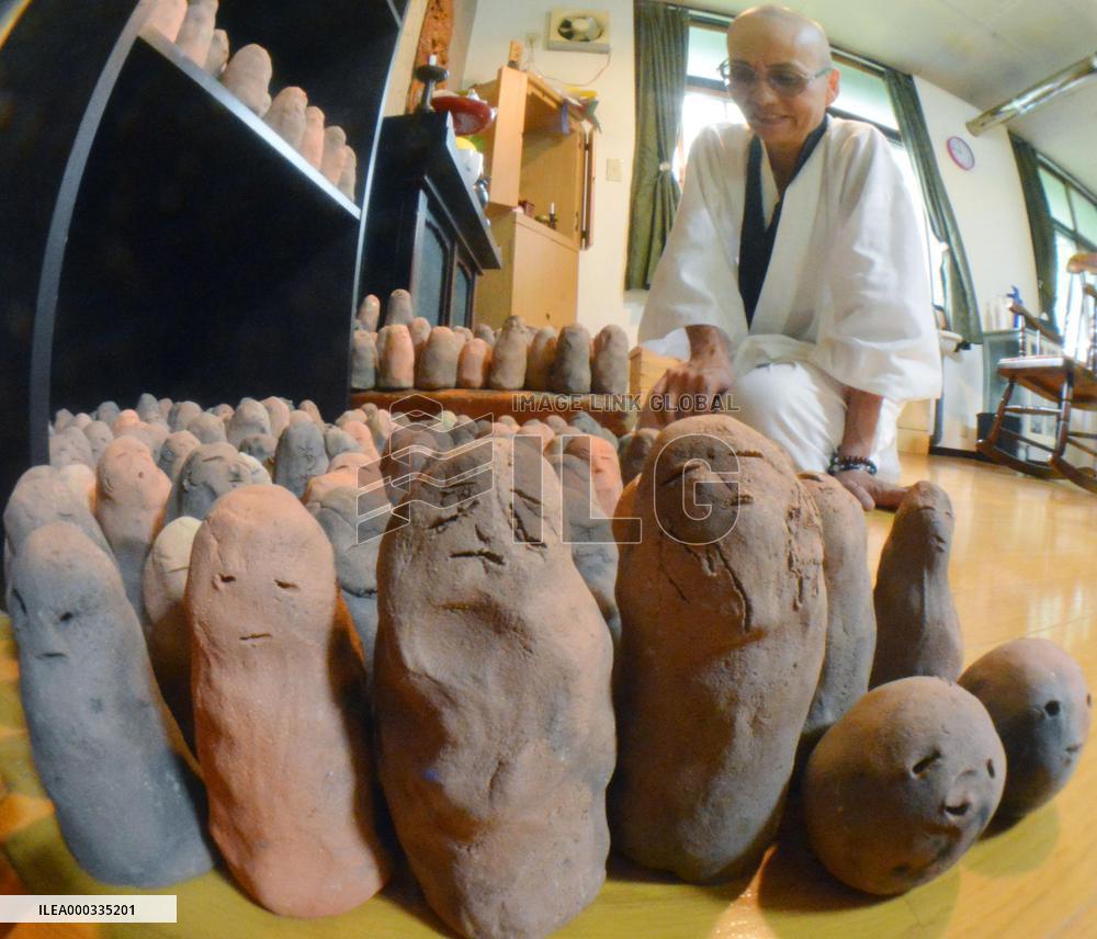 Fukushima nun bakes over 2,600 mud Buddhas for missing
