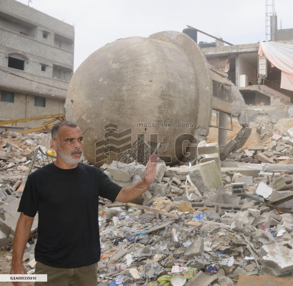 Man stands around destroyed building in Gaza