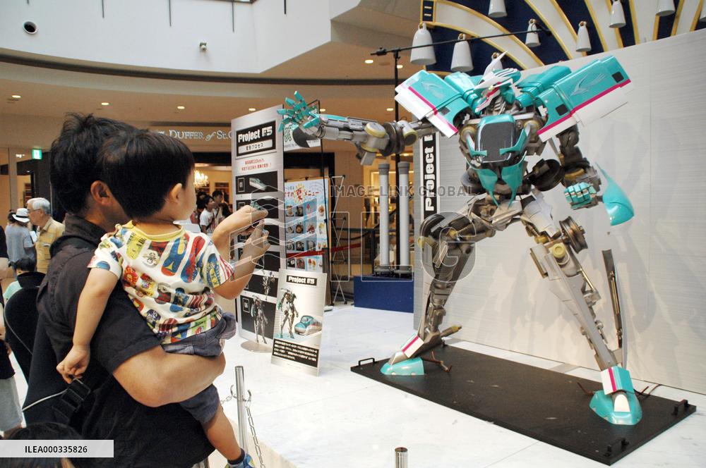 Visitors view E5 Shinkansen transformer robot