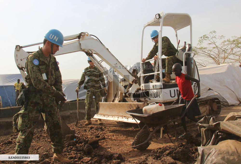 Refugee child passes by GSDF members in Juba