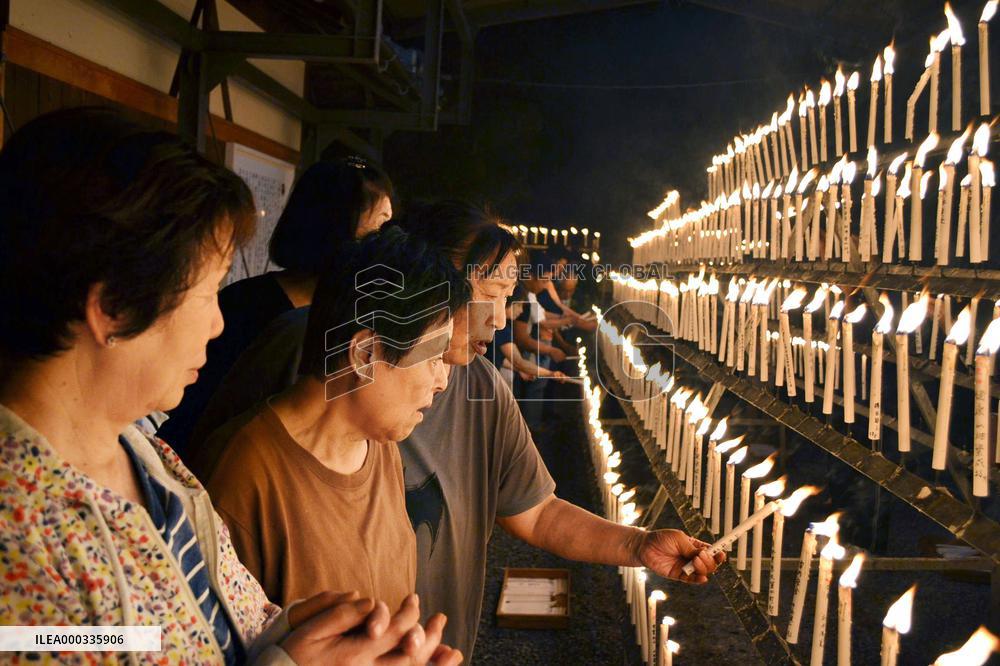 Well-wishers light candles at shrine in western Japan