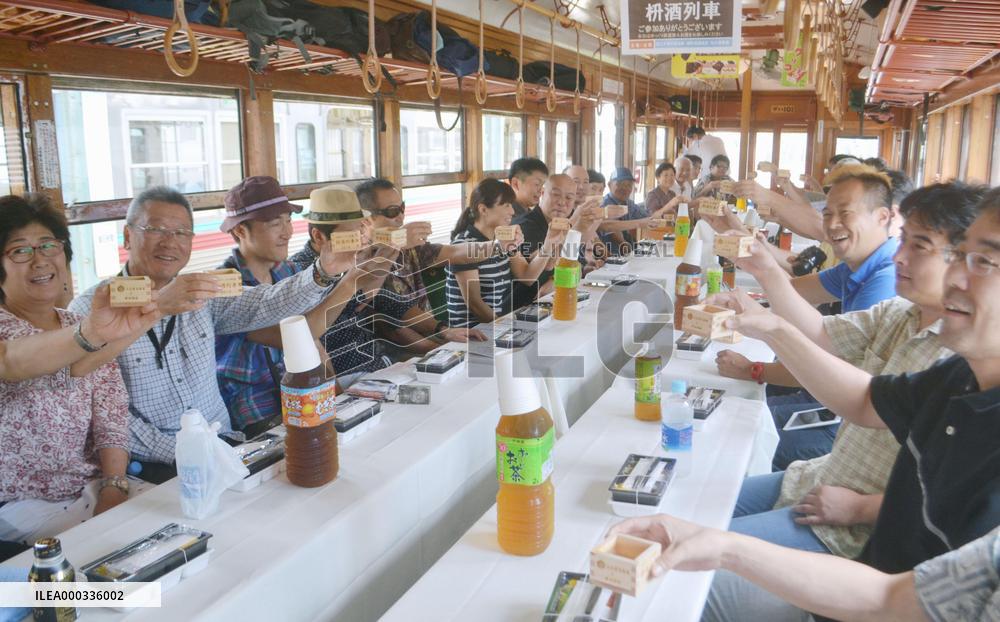 Passengers toast with sake on train in Japan