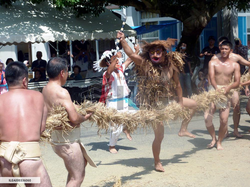 Man cuts rope during harvest festival on Amami-Oshima