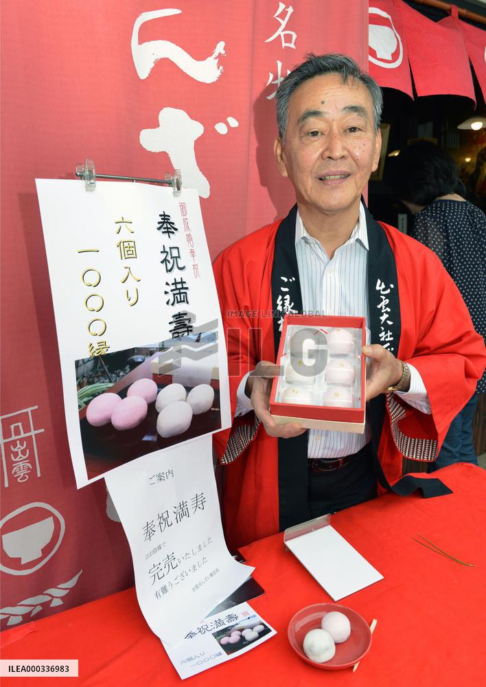 Store owner shows cake marking princess's wedding