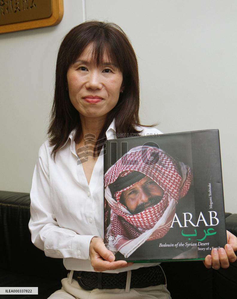 Japan photographer holds photo book of Syrian nomads