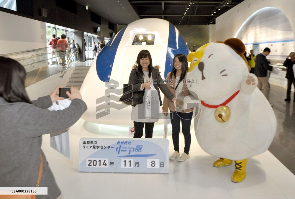 Tourists with local mascot at Yamanashi maglev center