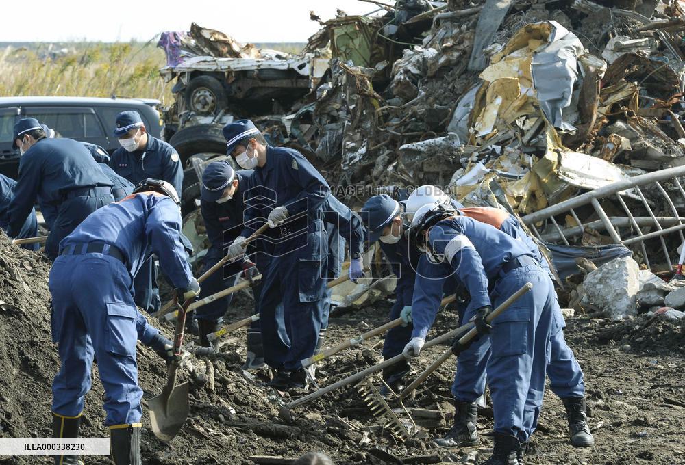 Fukushima police comb debris in coastal areas