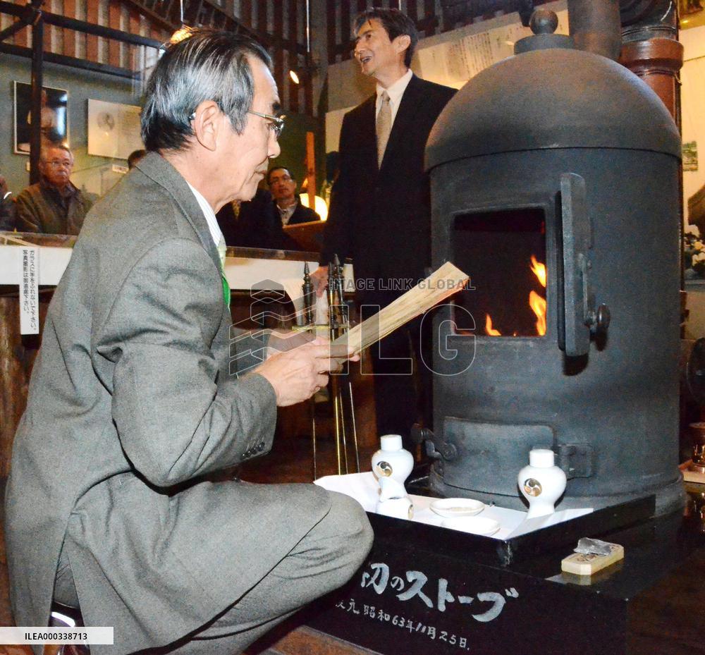 Feed wood in replica of Japan's 1st stove in Hokkaido