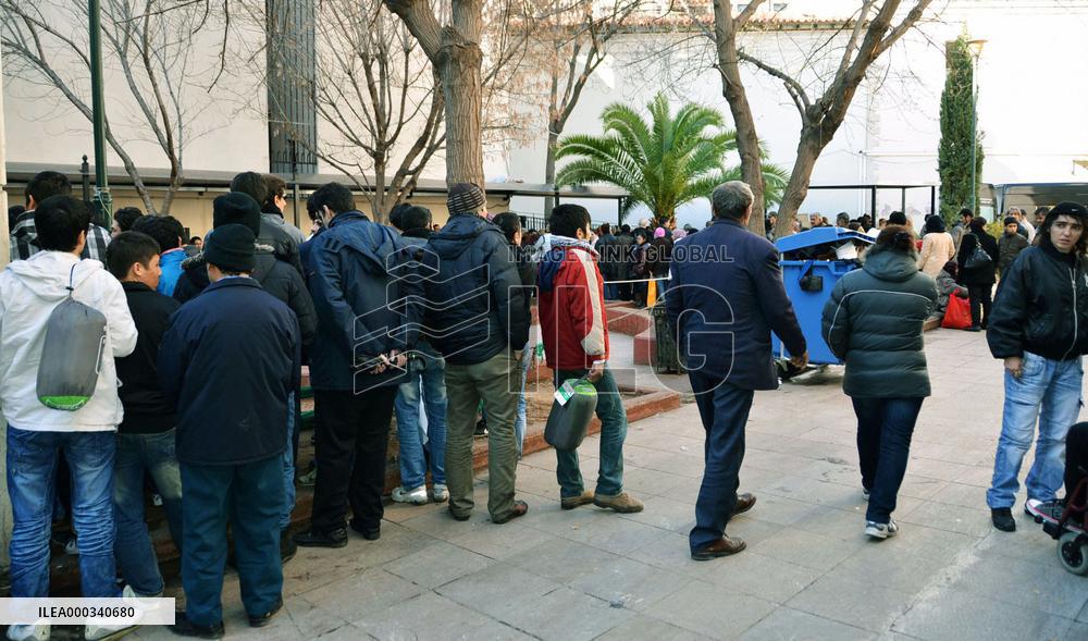 People line up for free meals in Athens