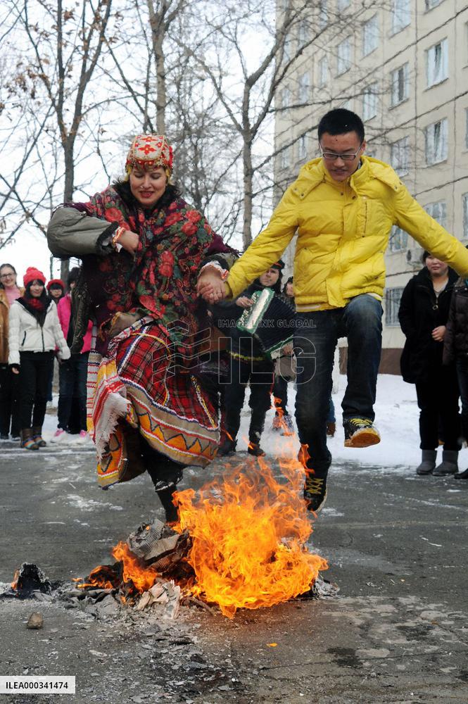 Jumping over burning straw effigy