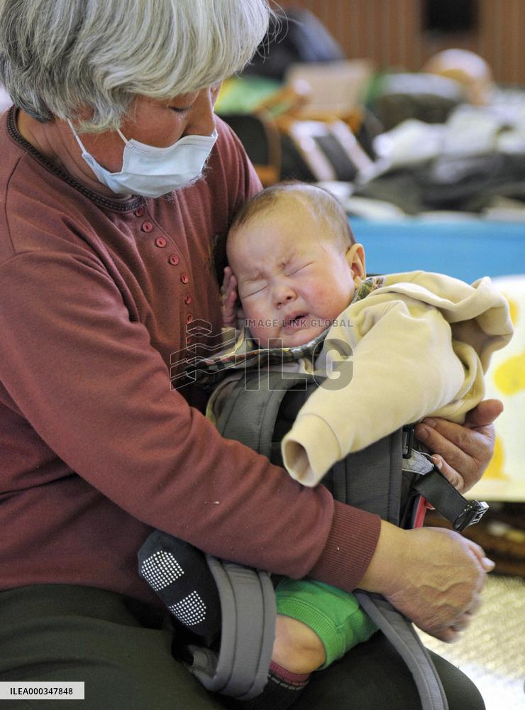 Baby and grandmother in evacuation center
