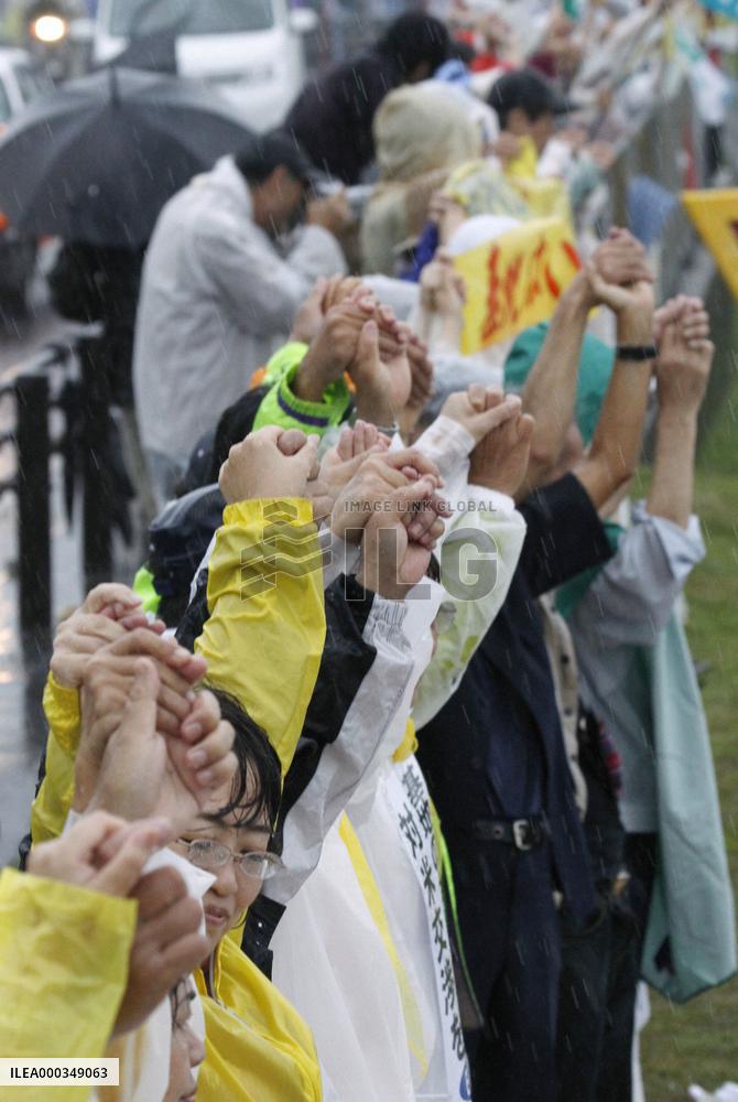 17,000 people encircle Futemma base in 'human chain'