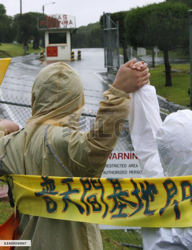 17,000 people encircle Futemma base in 'human chain'