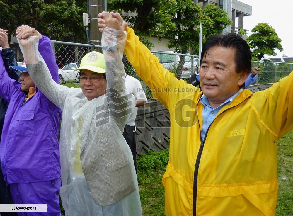 17,000 people encircle Futemma base in 'human chain'